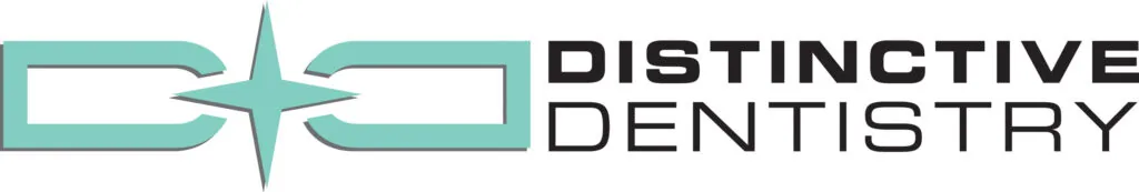 A teal and white logo featuring a stylized star symbol centered between two curved shapes. Faint text in the background reads “DISTINCTIVE DENTISTRY” with a clean, modern design on a plain white background.